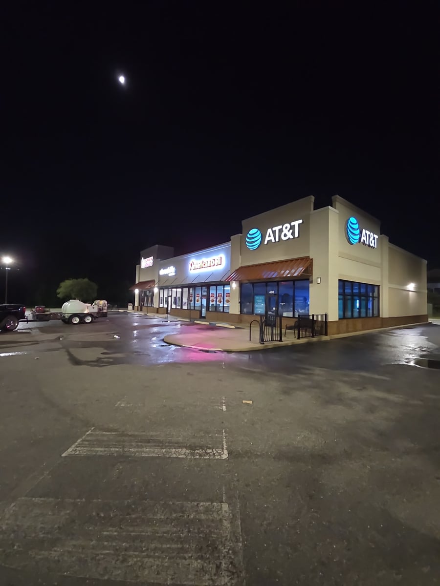 Soft washing building exterior and pressure washing sidewalks